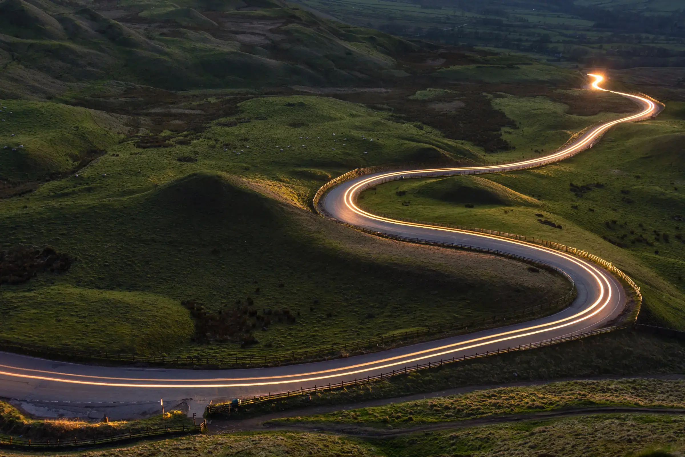 car-lights-streak-through-farmland